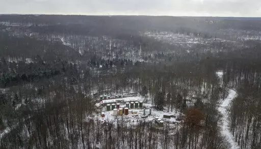 FILE -This Nov. 13, 2019, aerial photo shows part of an abandoned oil drilling project in the Allegheny National Forest in Pennsylvania. The U.S. Department of the Interior says 20 wells in that forest are among 277 “high priority” polluting orphan wells that will be cleaned up with $33 million from the bipartisan infrastructure act. The wells are on federal land in Pennsylvania, California, Kentucky, Louisiana, Ohio, Oklahoma, Texas, Utah and West Virginia.  (Andrew Rush/Pittsburgh Post-Gaz
