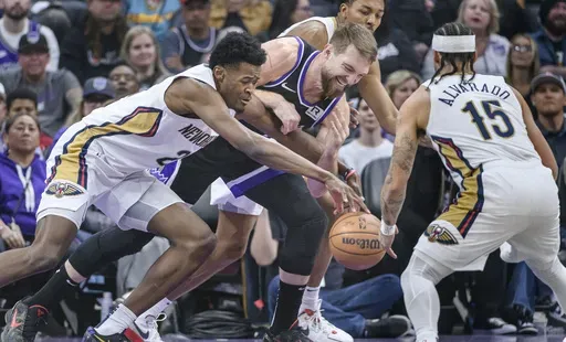 New Orleans Pelicans center Yves Missi, left, and Sacramento Kings forward Domantas Sabonis battle for the ball during the first half of an NBA basketball game in Sacramento, Calif., Saturday, Feb. 8, 2025. (AP Photo/Randall Benton)