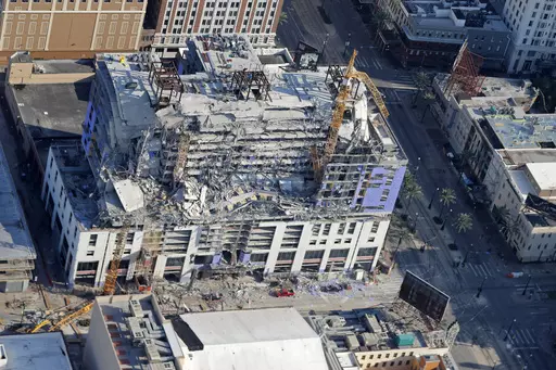 Two large cranes from the Hard Rock Hotel construction collapse are seen in this aerial photo after crashing down, after being detonated for implosion in New Orleans, Sunday, Oct. 20, 2019. A grand jury in Louisiana on Thursday, Oct. 5, 2023, has decided against indicting anyone in the deadly collapse hotel that had been under construction in New Orleans. (AP Photo/Gerald Herbert, File)