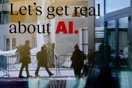 People are reflected in a window of a hotel at the Davos Promenade in Davos, Switzerland, Jan. 15, 2024. Artificial intelligence is supercharging the threat of election disinformation worldwide, making it easy for anyone to create fake – but convincing – content aimed at fooling voters. (AP Photo/Markus Schreiber, File)