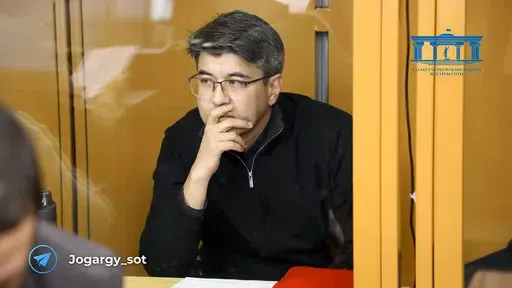 In this photo released by the Kazakhstan Supreme Court Press Office’s Telegram channel on Friday, April 12, 2024, businessman Kuandyk Bishimbayev, the country’s former economy minister, sits in a defendants’ cage at his trial in Astana, Kazakhstan. Bishimbayev is on trial for killing his wife, Saltanat Nukenova, and the case has touched a nerve in the Central Asian country, with tens of thousands of people signing petitions calling for harsher penalties for domestic violence. On April 11, 