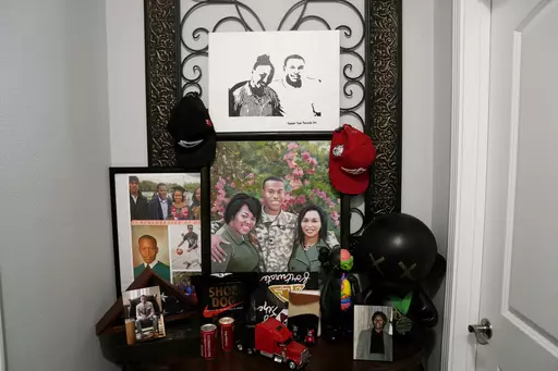 A hallway shrine to Dararius Evans, who was killed in January of 2020, is seen in the home of his mother Pamela White in Ponchatoula, La., Thursday, May 4, 2023. White and her family turned to Louisiana’s victim compensation board for help paying for the unexpected funeral. She was met with administrative hurdles, a denial that blamed her son for his own death, a lengthy appeal — all while paying up front through a personal loan that gathered interest as she waited. (AP Photo/Gerald Herbert)
