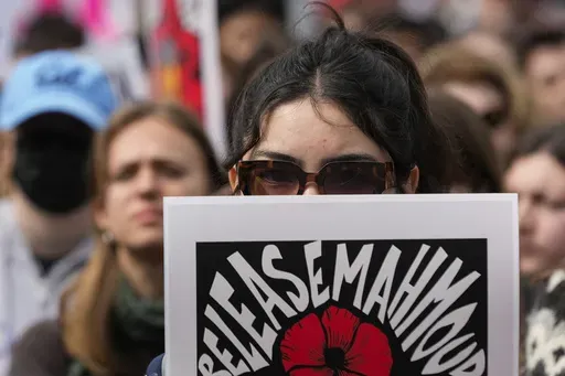 A person holds a sign in support of detained Palestinian activist Mahmoud Khalil while protesting the Trump administration at the University of California, Berkeley campus Wednesday, March 19, 2025, in Berkeley, Calif. (AP Photo/Godofredo A. Vásquez)