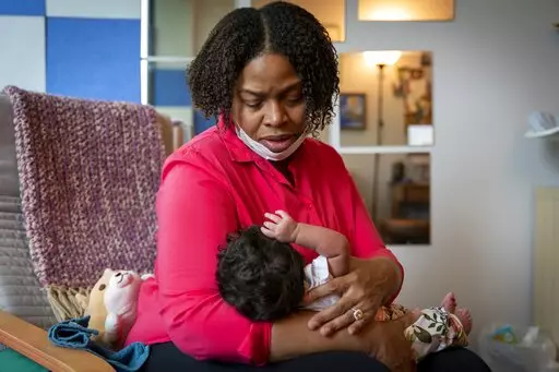 Capri Isidoro, of Ellicott City, Md., looks at her one-month-old baby Charlotte, Monday, May 23, 2022, in Columbia, Md., during a lactation consultation. Charlotte was delivered via emergency c-section and given formula by hospital staff. Isidoro has been having trouble with breastfeeding and has been searching for a formula that her daughter can tolerate well. "If all things were equal I would feed her with formula and breastmilk," says Isidoro, "but the formula shortage is so scary. I worry I 