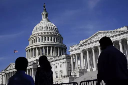 People walk outside the U.S Capitol building in Washington, June 9, 2022. President Joe Biden goes into Thursday's State of the Union address with an expanded plan to raise corporate taxes. He would use the proceeds to trim budget deficits and cut taxes for the middle class.(AP Photo/Patrick Semansky, File)