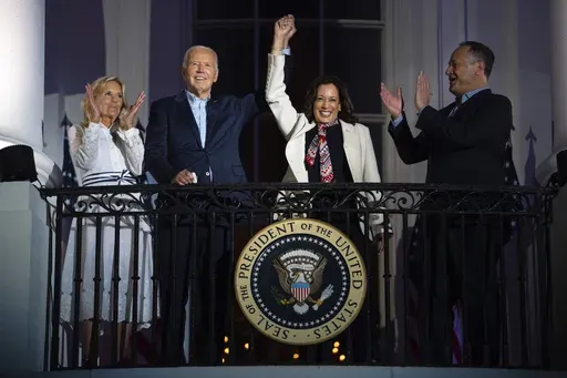 First lady Jill Biden, left, and second gentleman Douglass Emhoff, right, watch as President Joe Biden, center left, raises the hand of Vice President Kamala Harris as they view the Independence Day firework display over the National Mall from the balcony of the White House, July 4, 2024, in Washington. She's already broken barriers, and now Harris could soon become the first Black woman to head a major party's presidential ticket after President Joe Biden's ended his reelection bid. The 59-year