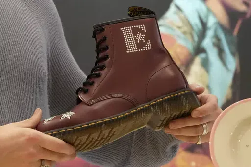 A Dr Martens boot inspired by Elton John's famous Pinball Wizard outfit is shown at a promotional event in London, March 20, 2023. Dr. Martens shares plunged more than 30% Tuesday, April 16, 2024 after the trendy British brand forecast that wholesale revenue in the U.S., its largest market, would decline by double-digits compared to that seen a year ago. (AP Photo/Kin Cheung, File)