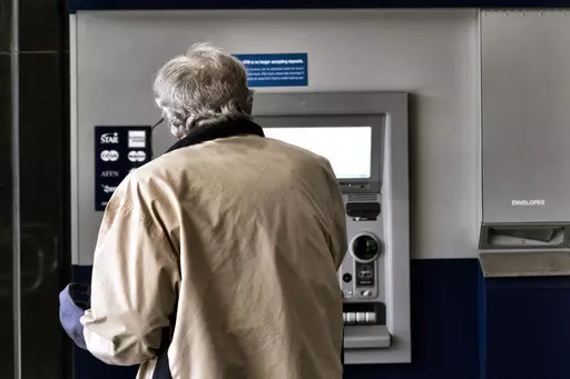 A customer makes a transaction at an automatic teller machine in Los Angeles on March 27, 2023. The cost to overdraw a bank account could drop to as little as $3 under a proposal announced by the White House, the latest move by the Biden administration to combat fees it says pose an unnecessary burden on American consumers, particularly those living paycheck to paycheck. (AP Photo/Richard Vogel, File)