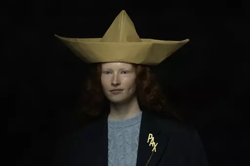 A model wears a creation as part of the Moschino women's Fall-Winter 2024-25 collection presented in Milan, northern Italy, Thursday, Feb. 22, 2024. (AP Photo/Antonio Calanni)