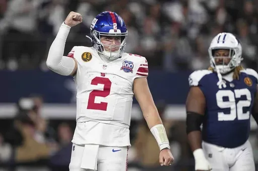 New York Giants quarterback Drew Lock (2) celebrates after running back Tyrone Tracy Jr. (29) scored a touchdown against the Dallas Cowboys during the first half of an NFL football game in Arlington, Texas, Thursday, Nov. 28, 2024. (AP Photo/Tony Gutierrez)