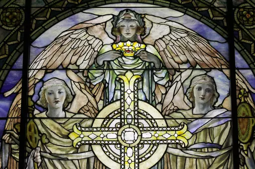 A detail of "The Righteous Shall Receive a Crown of Glory," Brainard Memorial Window for Methodist Church, Waterville, New York, ca. 1901 is photographed while on display at the "Louis C. Tiffany and the Art of Devotion" exhibit at the Museum of Biblical Art in New York on Thursday, Oct. 25 2012. About 7 in 10 U.S. adults say they believe in angels, according to a new poll released on Saturday, July 29, 2023, by The Associated Press-NORC Center for Public Affairs Research. (AP Photo/Mary Altaffe