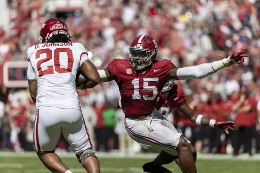 Alabama linebacker Dallas Turner (15) pursues Arkansas running back Dominique Johnson (20) during the second half of an NCAA college football game, Saturday, Oct. 14, 2023, in Tuscaloosa, Ala. Turner has been selected to The Associated Press midseason All-America team, Wednesday, Oct. 18, 2023.(AP Photo/Vasha Hunt, File)