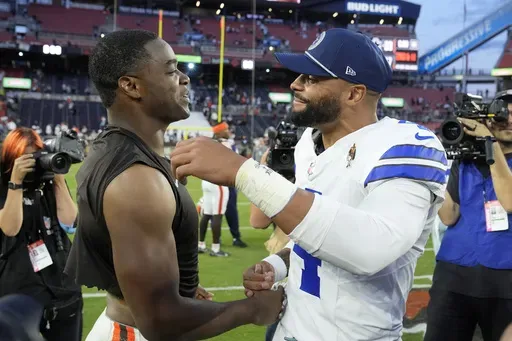 Cleveland Browns' Amari Cooper, left, and Dallas Cowboys' Dak Prescott, right, greet each other after their team's NFL football game in Cleveland, Sunday, Sept. 8, 2024. (AP Photo/Sue Ogrocki)