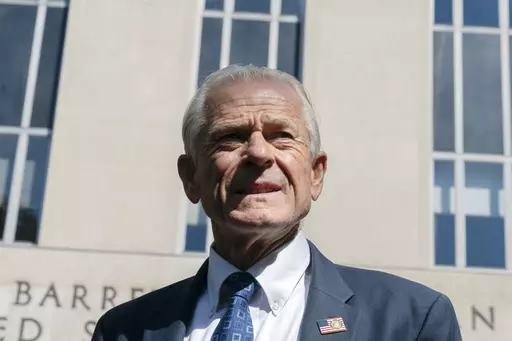 Former White House trade adviser Peter Navarro listens as his legal team talk to members of the media outside the federal court in Washington, Aug. 31, 2022. Navarro is scheduled to stand trial in September on contempt of Congress charges filed after he refused to cooperate with a congressional investigation into the Jan. 6 attack on the U.S. Capitol. A judge set the September 5 trial date on Tuesday. (AP Photo/Manuel Balce Ceneta, File)