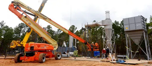 In this Dec. 10, 2015 photo, workers make preparations to dispose of M6 artillery propellant stored in bunkers at Camp Minden, in Minden, La. Three of the men who pleaded guilty in connection with what a prosecutor called the nation’s worst dumping of explosives still owe substantial restitution — one for nearly all of the $34.8 million he was ordered to pay, federal prosecutors say. The two others have paid all they were assessed.   (Henrietta Wildsmith/The Shreveport Times via AP)
