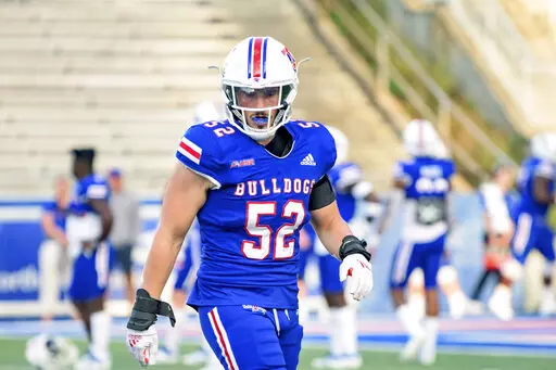 Louisiana Tech linebacker Tyler Grubbs (52) runs during an NCAA college football game against UTSA in Ruston, La., Saturday, Oct. 23, 2021. Here are six players going places in 2022, even if their teams aren’t: Arizona receiver Jacob Cowing, Louisiana Tech linebacker Tyler Grubbs, Kansas safety Kenny Logan Jr., Buffalo linebacker James Patterson, Northwestern offensive lineman Peter Skoronski and Syracuse running back Sean Tucker.(AP Photo/Matthew Hinton, File)