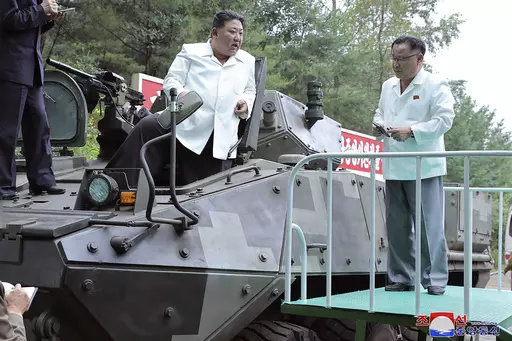 In this undated photo provided on Monday, Aug. 14, 2023, by the North Korean government, North Korean leader Kim Jong Un, center, rides on an armored vehicle during his Aug. 11-12 visit to a military factory in North Korea. Independent journalists were not given access to cover the event depicted in this image distributed by the North Korean government. The content of this image is as provided and cannot be independently verified. Korean language watermark on image as provided by source reads: "