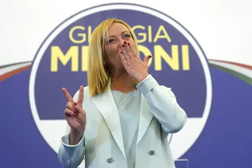 Far-Right party Brothers of Italy's leader Giorgia Meloni flashes the victory sign at her party's electoral headquarters in Rome, early Monday, Sept. 26, 2022. Italian voters rewarded Giorgia Meloni's euroskeptic party with neo-fascist roots, propelling the country toward what likely would be its first far-right-led government since World War II, based on partial results Monday from the election for Parliament. (AP Photo/Gregorio Borgia)