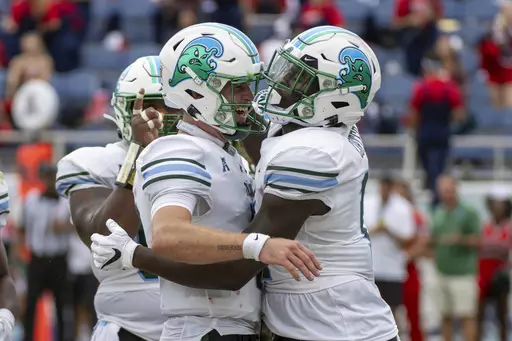 Tulane tight end Chris Carter (11) celebrates with quarterback Michael Pratt (7) after scoring a touchdown during the first half of an NCAA football game against Florida Atlantic, Saturday, Nov. 18, 2023 in Boca Raton, Fla. (AP Photo/Doug Murray)