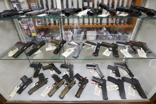 Semi-automatic handguns are displayed at shop in New Castle, Pa., March 25, 2020. A Biden administration rule requiring registration of stabilizing braces on handguns is unlikely to survive a legal challenge, a federal appeals court panel said Tuesday, Aug. 1, 2023, as it extended an order allowing a gun dealer and others challenging the regulation to keep owning, buying and selling the devices without registering them. (AP Photo/Keith Srakocic, File)