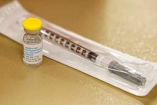 A vial containing the monkeypox vaccine and a syringe is set on the table at a vaccination clinic run by the Mecklenburg County Public Health Department in Charlotte, N.C., Saturday, Aug. 20, 2022. In the wake of a study released on Thursday, Sept. 8, 2022, U.S. officials are considering broadening recommendations for who gets vaccinated against monkeypox, possibly to include many men being treated for HIV or those who recently had other sexually transmitted infections. (AP Photo/Nell Redmond, F