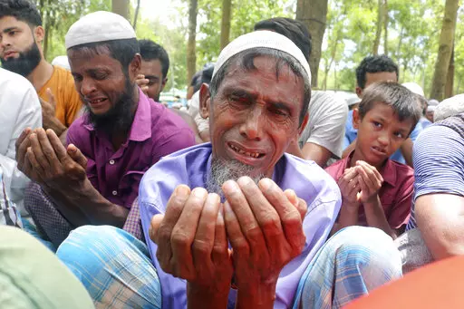 Rohingya refugees cry while praying during a gathering to mark the fifth anniversary of their exodus from Myanmar to Bangladesh, at a Kutupalong Rohingya refugee camp at Ukhiya in Cox's Bazar district, Bangladesh, Thursday, Aug. 25, 2022. Hundreds of thousands of Rohingya refugees on Thursday marked the fifth anniversary of their exodus from Myanmar to Bangladesh, while the United States, European Union and other Western nations pledged to continue supporting the refugees' pursuit of justice in 