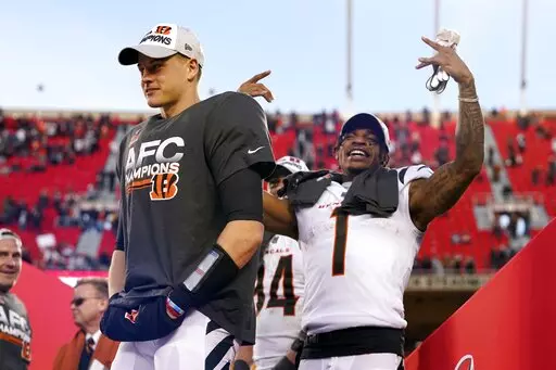 Cincinnati Bengals quarterback Joe Burrow, left, and wide receiver Ja'Marr Chase (1) celebrate after the AFC championship NFL football game against the Kansas City Chiefs, Sunday, Jan. 30, 2022, in Kansas City, Mo. The Bengals won 27-24 in overtime. (AP Photo/Eric Gay)
