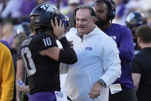 TCU head coach Sonny Dykes, right, talks to quarterback Josh Hoover (10) during the second half of an NCAA college football game against Arizona, Saturday, Nov. 23, 2024, in Fort Worth, Texas. (AP Photo/LM Otero)