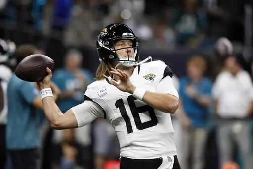 Jacksonville Jaguars quarterback Trevor Lawrence (16) warms before an NFL football game against the New Orleans Saints in New Orleans, Thursday, Oct. 19, 2023. (AP Photo/Butch Dill)