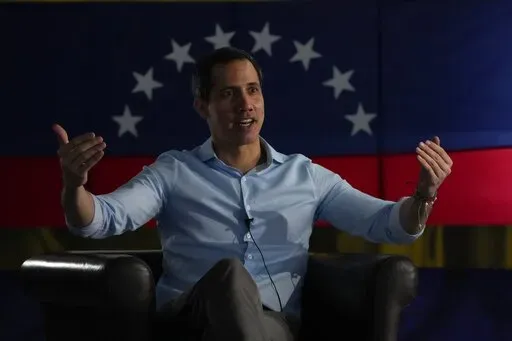 Opposition leader Juan Guaido speaks during an interview with the Associated Press in Caracas, Venezuela, Thursday, Feb. 10, 2022. Three years after he proclaimed himself the legitimate leader of Venezuela, Guaido, his U.S.-backed opposition and other adversaries of President Nicolas Maduro will convene this week in Caracas, to work on a big-tent strategy as they gear up for a presidential election they would like to see happen before 2024. (AP Photo/Ariana Cubillos)