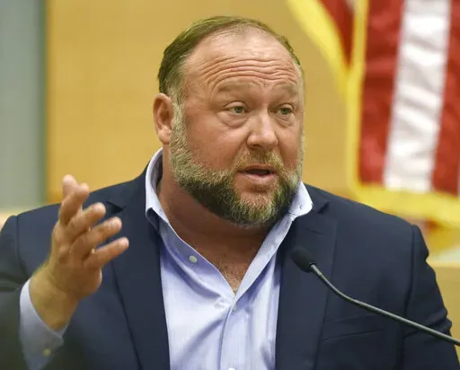 Conspiracy theorist Alex Jones takes the witness stand to testify at the Sandy Hook defamation damages trial at Connecticut Superior Court in Waterbury, Conn. Thursday, Sept. 22, 2022.  On Friday, Oct. 21, Jones has asked a Connecticut judge to throw out a nearly $1 billion verdict against him and order a new trial in a lawsuit by Sandy Hook families over Jones' lies that the 2012 Newtown school shooting was a hoax.(Tyler Sizemore/Hearst Connecticut Media via AP, Pool, File)