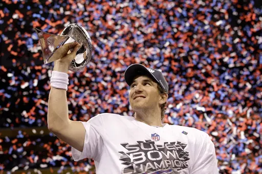 New York Giants quarterback Eli Manning holds up the Vince Lombardi Trophy while celebrating his team's 21-17 win over the New England Patriots in the NFL Super Bowl XLVI football game, Feb. 5, 2012, in Indianapolis. (AP Photo/David J. Phillip, File)