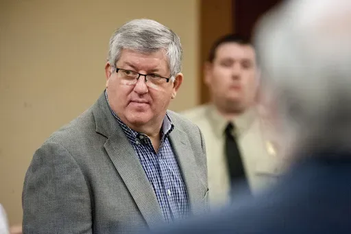 Bernie Tiede, left, stands in court during day nine of his new sentencing trial, April 18, 2016, at the Rusk County Justice Center in Henderson, Texas. Tiede, the former mortician serving a life sentence for killing widow Marjorie Nugent in 1996, sued the Texas prison system for stiflingly hot conditions he said endangered his life. (Michael Cavazos/The News-Journal via AP, Pool, File)
