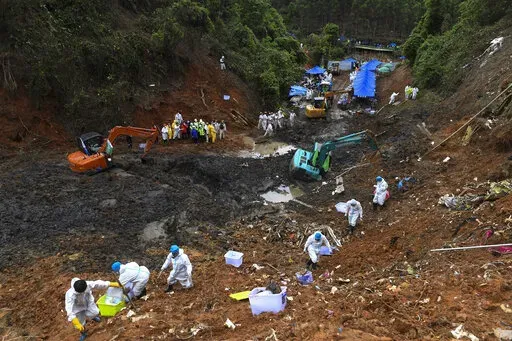 CORRECTS NUMBER OF THE VICTIMS - In this photo released by Xinhua News Agency, search and rescuer workers conduct continued search operations at the China Eastern flight crash site in Tengxian County on Saturday, March 26, 2022, in southern China's Guangxi Zhuang Autonomous Region. The second "black box" has been recovered from the crash of a China Eastern Boeing 737-800 that killed 132 people last week, Chinese state media said Sunday. (Lu Boan/Xinhua via AP)