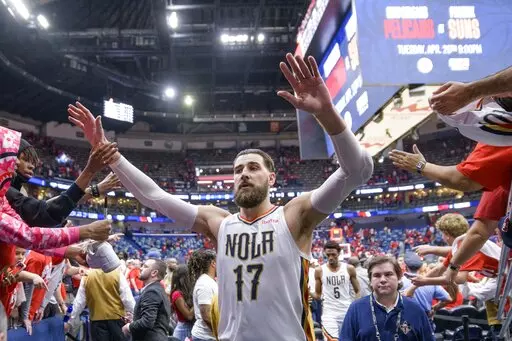 New Orleans Pelicans center Jonas Valanciunas (17) is congratulated by fans after the Pelicans 118-103 victory against the Phoenix Suns in Game 4 of an NBA basketball first-round playoff series in New Orleans, Sunday, April 24, 2022. (AP Photo/Matthew Hinton)