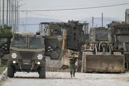 Israeli army vehicles are seen during a military operation in the West Bank city of Jenin, Wednesday, Jan. 22, 2025. (AP Photo/Majdi Mohammed)