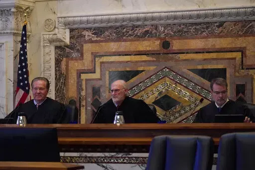 Judges Milan D. Smith Jr., from left, sits on a panel with Sidney R. Thomas and Michael J. McShane before hearing arguments at the Ninth Circuit Court of Appeals in San Francisco, Monday, Nov. 14, 2022. Apple is heading into a courtroom faceoff against Epic Games, the company behind the popular Fortnite video game, reviving a high-stakes antitrust battle over whether the digital fortress shielding the iPhone's app store illegally enriches the world's most valuable company while stifling competit