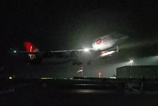 A repurposed Virgin Atlantic Boeing 747 aircraft, named Cosmic Girl, carrying Virgin Orbit's LauncherOne rocket, takes off from Spaceport Cornwall at Cornwall Airport, Newquay, England, on Jan. 9, 2023. Virgin Orbit said Thursday March 16, 2023 it is pausing all operations amid reports that the company is furloughing almost all its staff as part of a bid to seek a funding lifeline. (Ben Birchall/PA via AP)