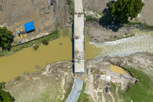 A bridge along KY-3351 over Troublesome Creek near Ary in Perry County, Ky., remains damaged Tuesday, Aug. 2, 2022, following flooding the week before that devastated many counties in Eastern Kentucky. Kentucky will receive up to 300 donated travel trailers from Louisiana to shelter people displaced by historic flooding that ravaged parts of Appalachia, the governors of both states said Wednesday, Aug. 31.  The first 65 donated trailers are being transported this week to a couple of hard-hit eas