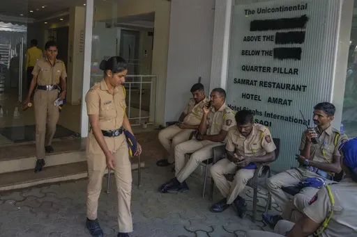 Police officers gather outside the building of the studio where Indian comedian Kunal Kamra allegedly made "defamatory" remarks against Shiv Sena politician Eknath Shinde and was ransacked by Shiv Sena party workers, in Mumbai, India, Monday, March 24, 2025. (AP Photo/Rafiq Maqbool)