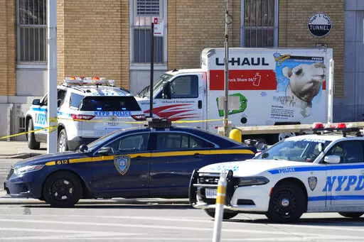 Police vehicles surround a truck that was stopped and the driver arrested, Monday, Feb. 13, 2023, in New York. Police stopped the U-Haul truck and detained the driver after reports that the vehicle struck multiple pedestrians in New York City on Monday. Authorities say the driver of the truck fled the scene after mounting a sidewalk in the Bay Ridge neighborhood of Brooklyn and injuring several people. (AP Photo/John Minchillo)