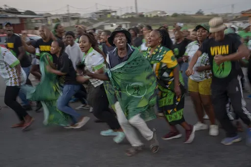 MK Party supporters celebrate in the middle of the street in Mahlbnathini village in rural KwaZulu-Natal, South Africa, on Thursday May 30, 2024. MK Party is currently leading in the provincial poll against the ANC, who've held the stronghold in the province for the last 20 years. (AP Photo/Emilio Morenatti)