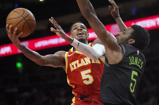 Atlanta Hawks guard Dejounte Murray (5) goes in for a shot as New Orleans Pelicans forward Herbert Jones (5) defends during the second half of an NBA basketball game Sunday, March 10, 2024, in Atlanta. (AP Photo/John Bazemore)