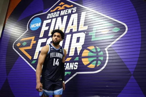 Villanova's Caleb Daniels (14) walks down the hallway at the men's Final Four NCAA college basketball tournament Thursday, March 31, 2022, in New Orleans. Villanova will play Kansas on Saturday. (AP Photo/David J. Phillip)