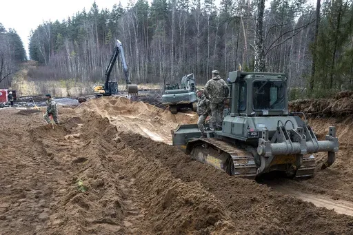 Recovery efforts continue for four missing U.S. soldiers near the spot where their Hercules armored vehicle was found submerged at a training range in Pabrade, north of the capital Vilnius, Lithuania on Thursday, March 27, 2025. (AP Photo/Mindaugas Kulbis)