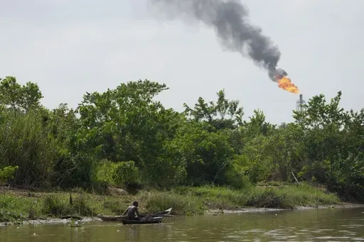 A man paddles his canoe in the Niger Delta near the village of Ogboinbiri, Nigeria, Dec. 11, 2024. (AP Photo/Sunday Alamba, File)