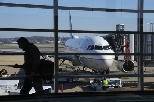 A United Airlines plane sits at a gate at Ronald Reagan Washington National Airport in Arlington, Va., Nov. 23, 2022. United Airlines says that it will start boarding passengers in economy class with window seats first starting next week, a move that will speed up boarding times for flights. (AP Photo/Patrick Semansky, File)