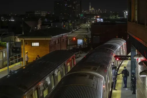 New York Police officers clear a train at the Coney Island Stillwell Avenue Terminal, May 5, 2020, in the Brooklyn borough of New York. (AP Photo/Frank Franklin II, file)