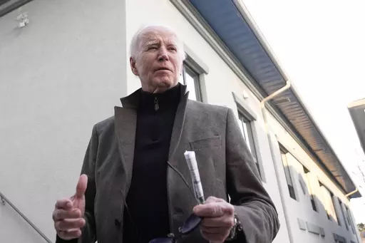 President Joe Biden speaks with reporters as he leaves St. Edmund Roman Catholic Church in Rehoboth Beach, Del., Saturday, Feb. 17, 2024, after attending a Mass. On Friday, Feb. 23, The Associated Press reported on stories circulating online incorrectly claiming Biden issued Executive Order 9066, which provides people who enter the U.S. illegally with a $5,000 Visa gift card. (AP Photo/Alex Brandon, File)