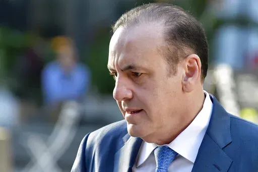 FILE— Gamal Abdelaziz arrives at federal court for his trial, Thursday, Oct. 7, 2021, in Boston. Abdelaziz, a former casino executive from Las Vegas who was found guilty in his college admissions bribery trial, is scheduled to be sentenced on Wednesday Feb. 9, 2022. (AP Photo/Josh Reynolds, File)